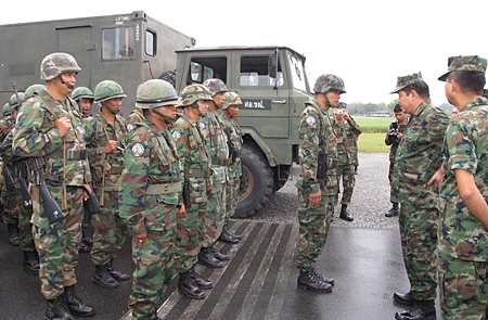Senior Capt. Suthinan Samarak, Commander of Air Force Command 2, inspects his troops before military exercises begin.